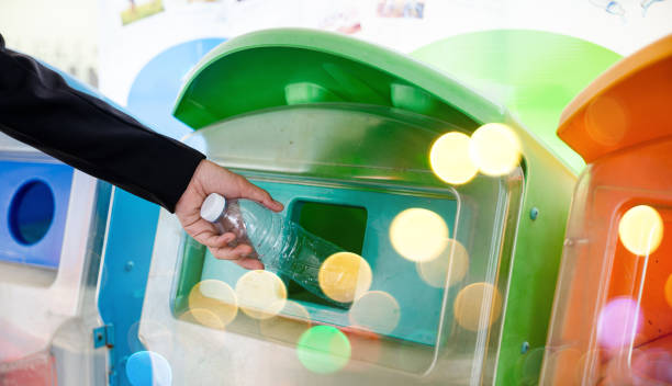 istock Business woman throwing empty plastic bottle water into recycle garbage trash 1437809721