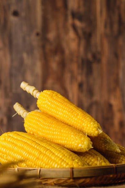 istock Group of corn cob in tray on wood table and wall 1437810980