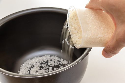 Put raw rice into the rice cooker pot