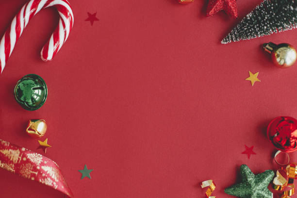istock Modern christmas flat lay. Stylish christmas candy cane, confetti and decorations frame on red background. Season's greetings card, space for text. Merry Christmas and Happy Holidays! Festive banner 1437812770