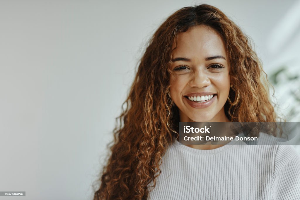 Face, portrait and happy with a black woman feeling positive, carefree or cheerful inside with a smile. Hair, teeth and beauty with an attractive young female posing with mockup for advertising Face, portrait and happy with a black woman feeling positive, carefree or cheerful inside with a smile. Hair, teeth and beauty with an attractive young female posing next to mockup for advertising One Woman Only Stock Photo
