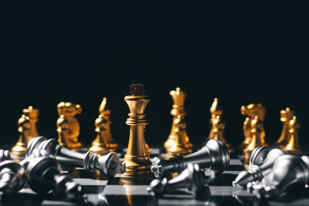 close-up king standing on a chessboard. there's a falling chess in front, leadership. teamwork business team challenges, global industry winners. - board game color image photography nobody imagens e fotografias de stock