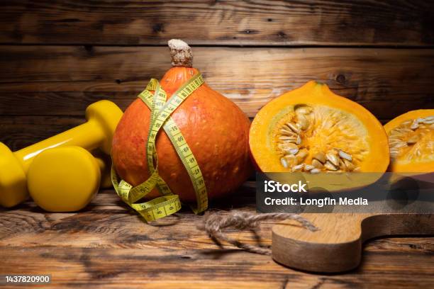 Gym Dumbbells With Hokkaido Pumpkins And Tape Measure Autumn Or Fall Rustic Composition Stock Photo - Download Image Now