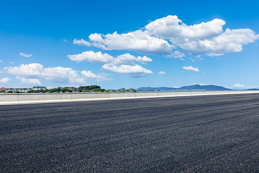 Asphalt road and skyline with sky cloud background