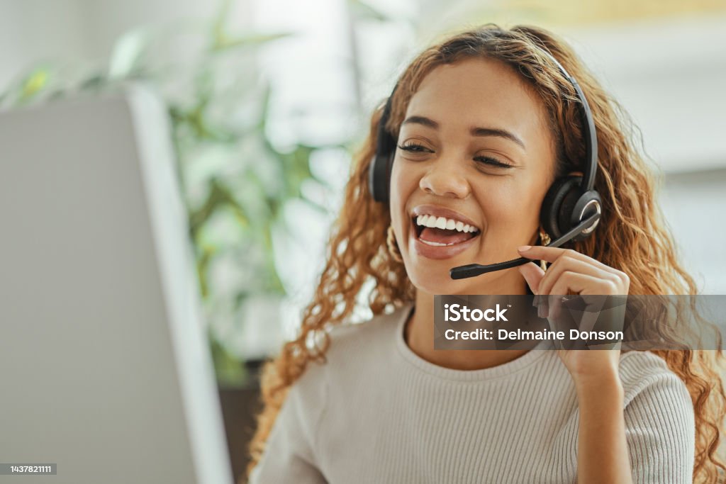Customer service, happy and communication of woman at call center pc talking with joyful smile. Consultant, advice and help desk girl speaking with clients online with computer headset mic. Customer Service Representative Stock Photo