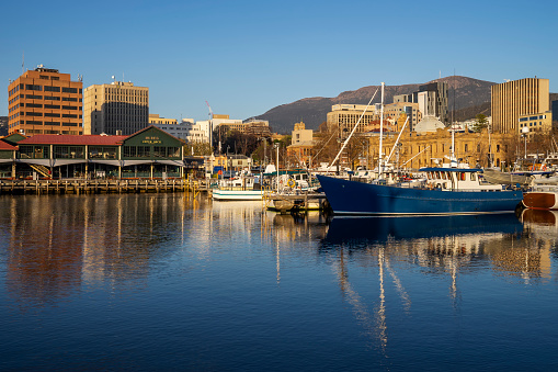 Boats moored around Victoria Dock in Hobart, Tasmania, Australia at sunrise, with Mount Wellington in the background.