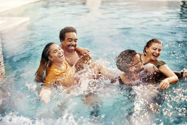 istock Cheerful couples having fun in summer day at the pool. 1437822204