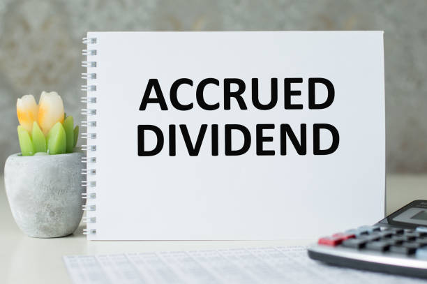 istock accrued DIVIDEND, text on a notepad on table, business concept 1437822384