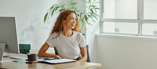 Black woman, modern finance office and smile by desk with corporate business financial document or accounting report. An African girl accountant, happy investment employee and international workplace