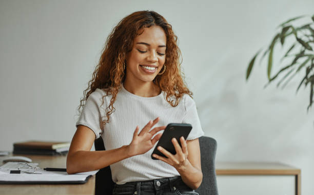 istock Office woman, smartphone at work and relax with a smile using 5g network connection to scroll internet social media on a working break. Business employee, online phone conversation and mobile texting 1437824147