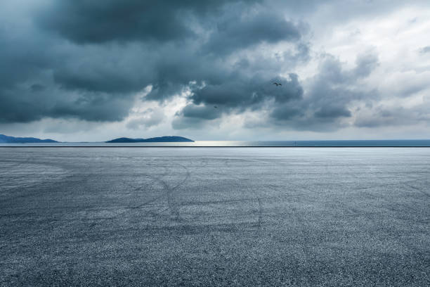 istock Asphalt road and lake with island 1437824298