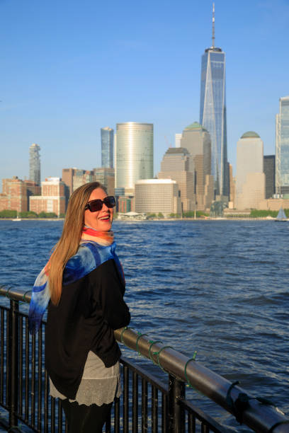 Pretty active women wears a headscarf enjoying in Panorama of New York City skyline Lower Manhattan Pretty active women wears a headscarf enjoying in Panorama of New York City skyline Lower Manhattan and the Freedom Tower new york marathon photos stock pictures, royalty-free photos & images