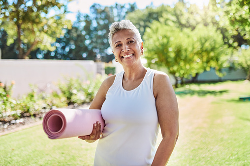 Yoga, senior woman and prepare for meditation for wellness, fitness or health outdoor or yoga mat. Elderly female, healthy lady or ready for workout, exercise or training for retired, smile or happy