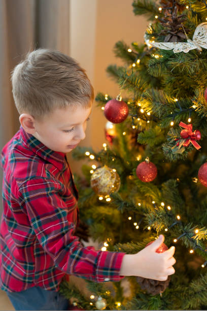 istock Little boy is decorating the Christmas tree 1437827306