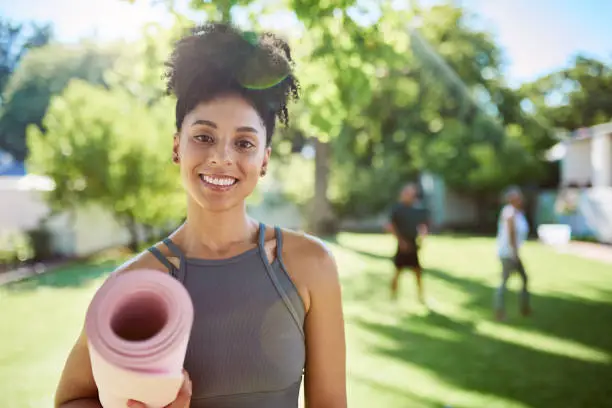 Photo of Yoga, yoga mat and black woman, fitness outdoor and exercise motivation for active lifestyle in happy portrait. Young African American, smile and pilates, body training and workout in nature.