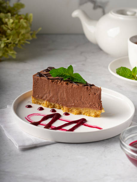istock chocolate cheesecake with chocolate glaze on white marble background. Vertical 1437827375