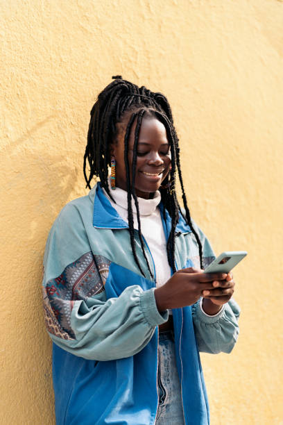 istock Happy African Woman Using Phone 1437827439