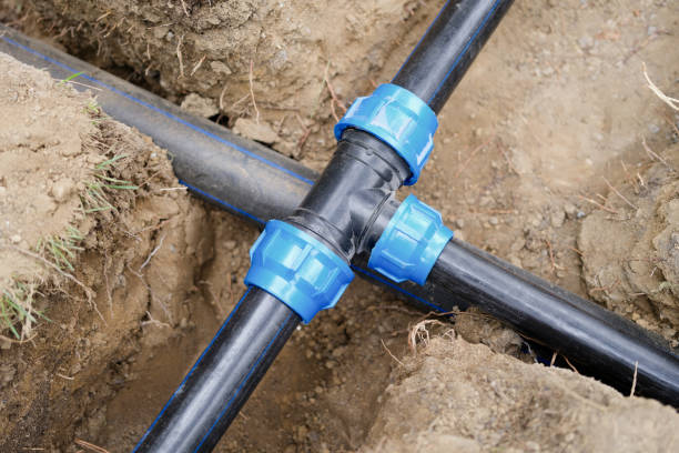 istock Installed PVC water pipes in trench at construction site 1437828397