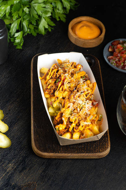 carne asada french fries on cardboard plate take away concept