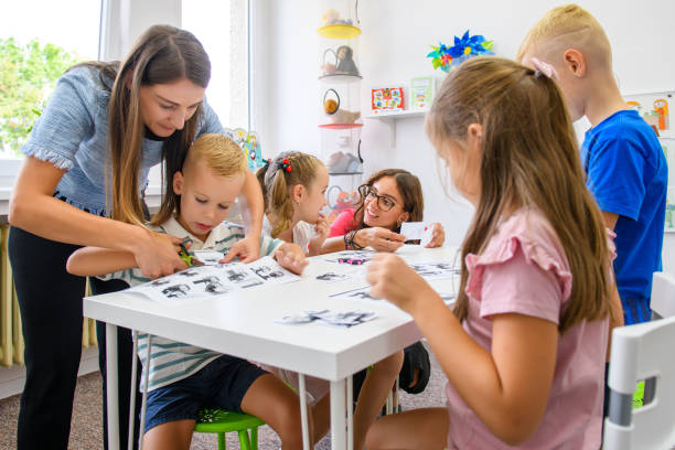 Child occupational therapy background. Elementary age children in group therapy. Teacher and pupils in class. Child occupational therapy background. Elementary age children in group therapy. Teacher and pupils in class. special education stock pictures, royalty-free photos & images