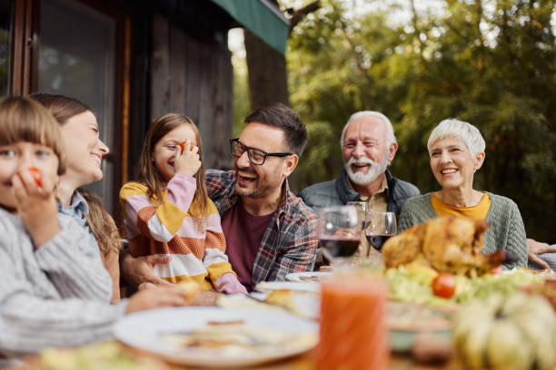 istock Cheerful extended family having fun during lunch on a terrace. 1437830042