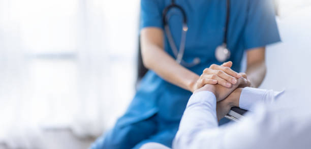 cropped shot of a female nurse hold her senior patient's hand. giving support. doctor helping old patient with alzheimer's disease. female carer holding hands of senior man - azië fotos stockfoto's en -beelden