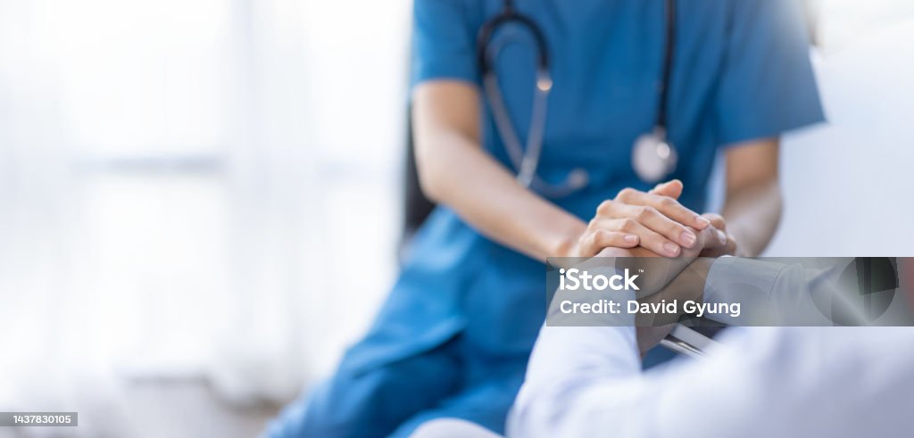 Cropped shot of a female nurse hold her senior patient's hand. Giving Support. Doctor helping old patient with Alzheimer's disease. Female carer holding hands of senior man Healthcare And Medicine Stock Photo