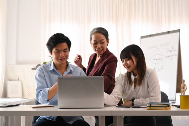 istock Senior female project leader explaining, discussing business plan marketing strategy with young employee. 1437832144