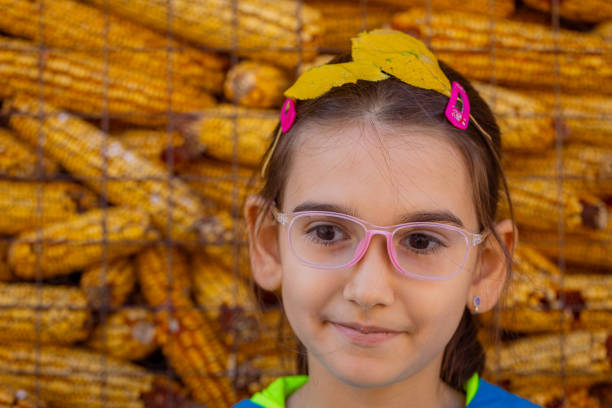 Smart girl portrait on yellow background