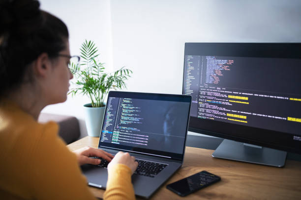 istock Young woman coding on a laptop at home office. 1437832785