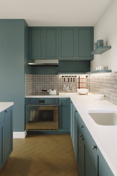 istock Green kitchen with an island. 3D rendering of a kitchen with tall cabinets and kitchen utensils. 1437834185