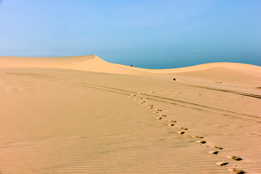 Footprints on the beautiful coastal sand dunes in the town of Mui Ne in South Vietnam.