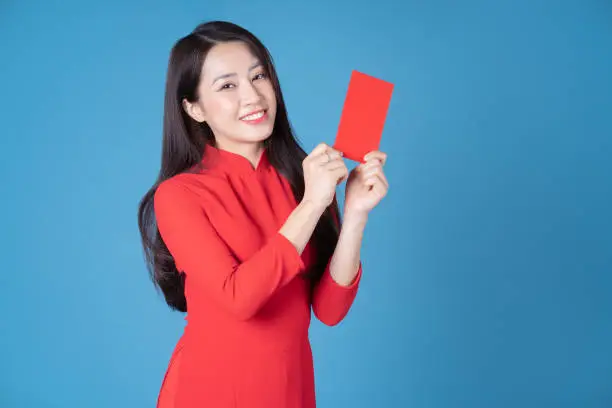 Photo of young Vietnamese woman wearing red ao dai