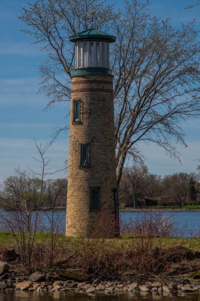 istock Vertical shot of the Asylum Lighthouse with trees around it, Wisconsin, US 1437836951