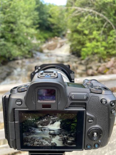 istock Vertical shot of a camera photographing a waterfall 1437836993