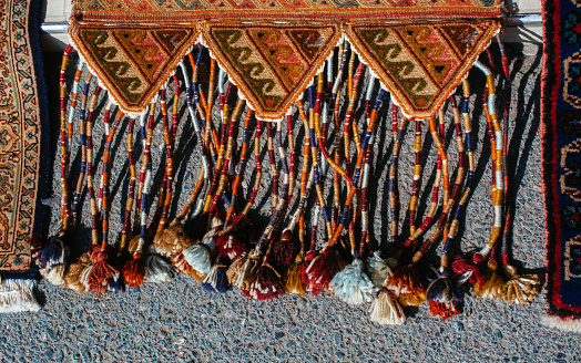 A top vertical of a colorful carpet. Detailed shapes of a carpet on the ground. Rug making art