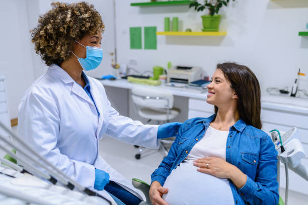 Pregnant woman visiting a dentist stock photo