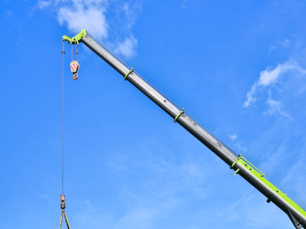 istock Isolated section of a heavy-duty crane machine lifting a container 1437840242