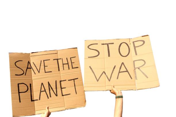 istock Two Cardboard Signs saying Save the planet and Stop War held by hands 1437840519