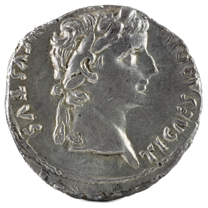 A closeup shot of ancient Roman denarius coin with emperor Tiberius engraving