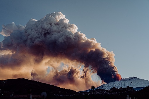 A dramatic view of dense smoke clouds coming out of erupting volcano