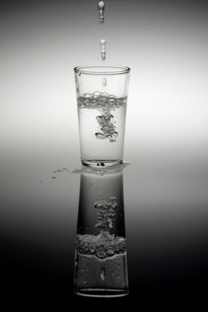 istock Pouring liquid into small shot glass 1437841100