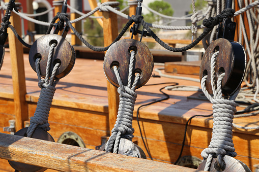 A selective focus shot of ropes for securing the sails of a sailboat