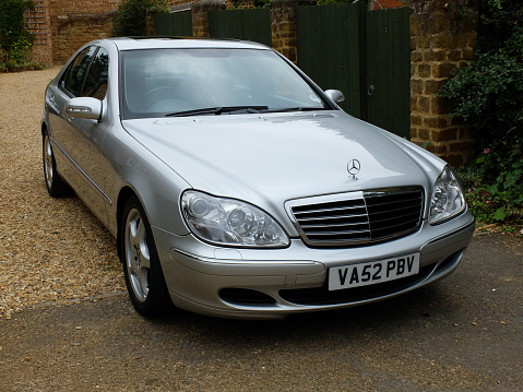 Northampton, United Kingdom – September 05, 2013: A silver mercedes sits in a driveway