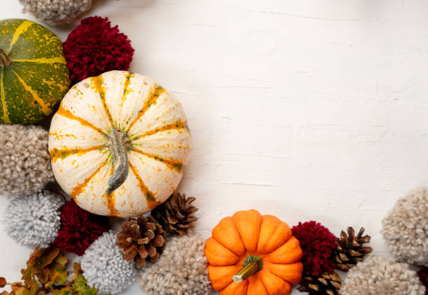 istock Pumpkins and yarn pompoms with space for your text - autumn themed background 1437842368