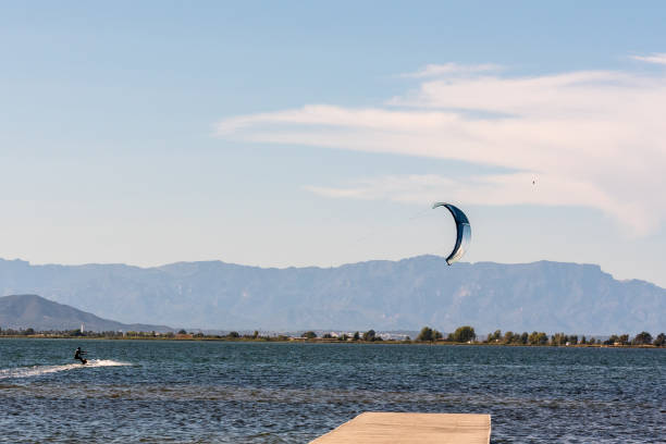Delta del Ebro, Spain – October 13, 2020: Delta del Ebro, Spain: September 28: People practicing kite Surfing in Platja del Trabucador in the Delta del Ebro, Tarragona, Spain in summer 2020
