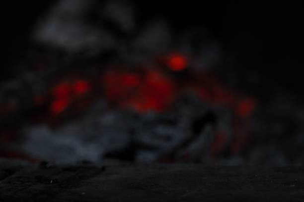 istock Dark stone product display surface foreground with fireplace flame in background 1437843263