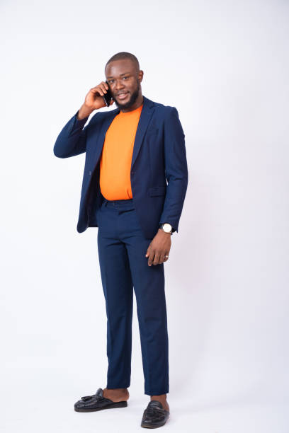 istock Young Nigerian businessman making a phone call isolated on a white background 1437844026