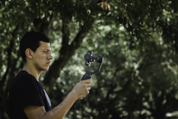 istock Young man filming nature with a smartphone on a stabilizer 1437846300