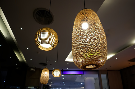 Lamps made of bamboo and rattan adorn the ceiling, Interior design background